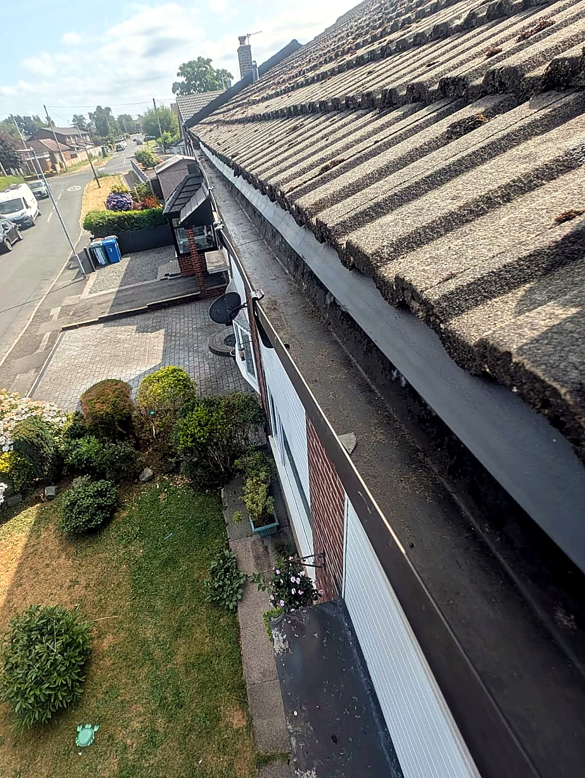 Clean, clear gutter run along a house roofline after gutter cleaning in Bolton, Greater Manchester